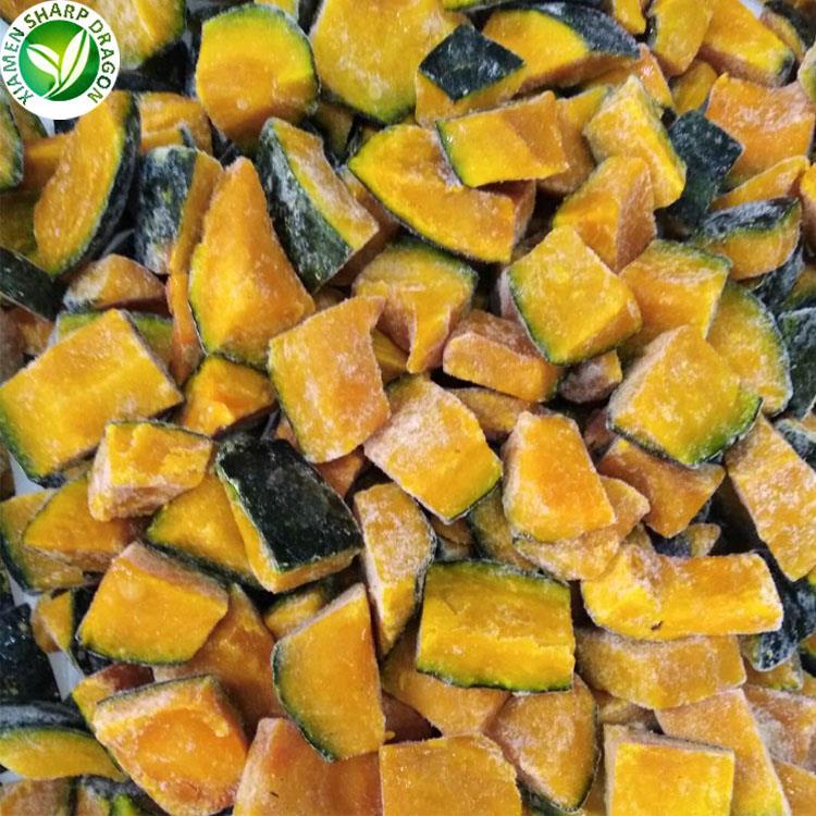 Frozen pumpkin pieces with orange flesh and dark green rind