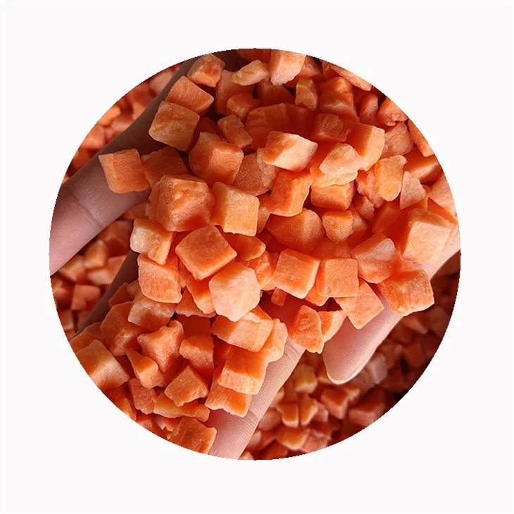 Carrot pieces vary even within one cut style Frozen orange carrot dice held in a hand to show piece-size variation