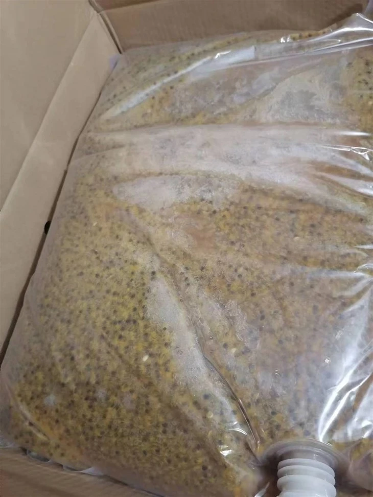 Passion-fruit seed and pulp distribution for blend specification Frozen passion fruit pulp with visible seed distribution in bulk liners