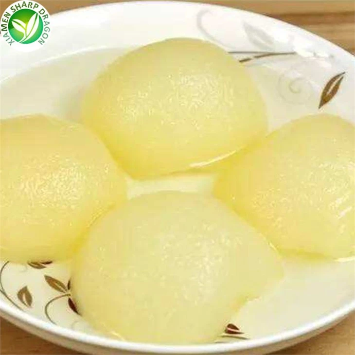 Peeled pear halves arranged in a shallow dish