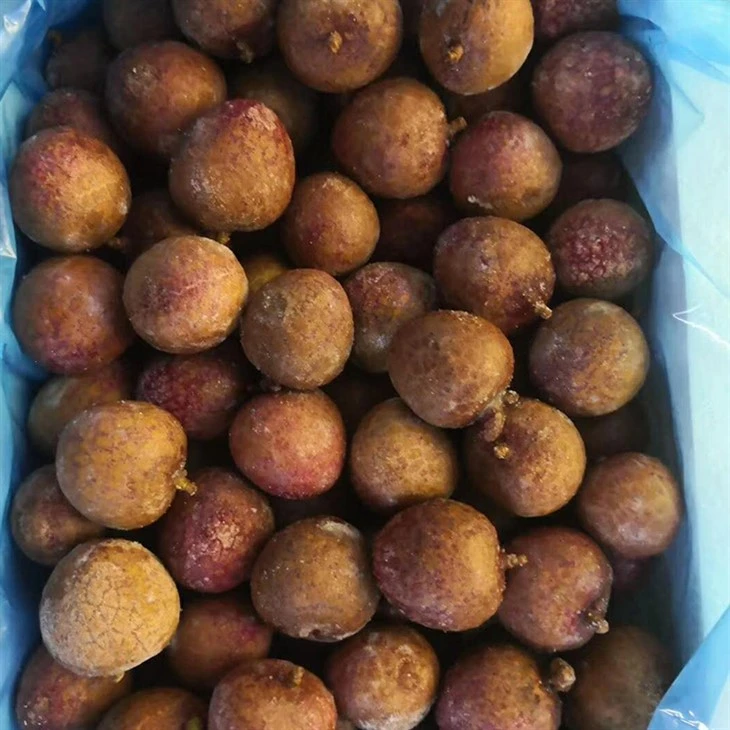 Whole frozen lychee shell and size inspection Frozen whole lychees showing shell color and size variation